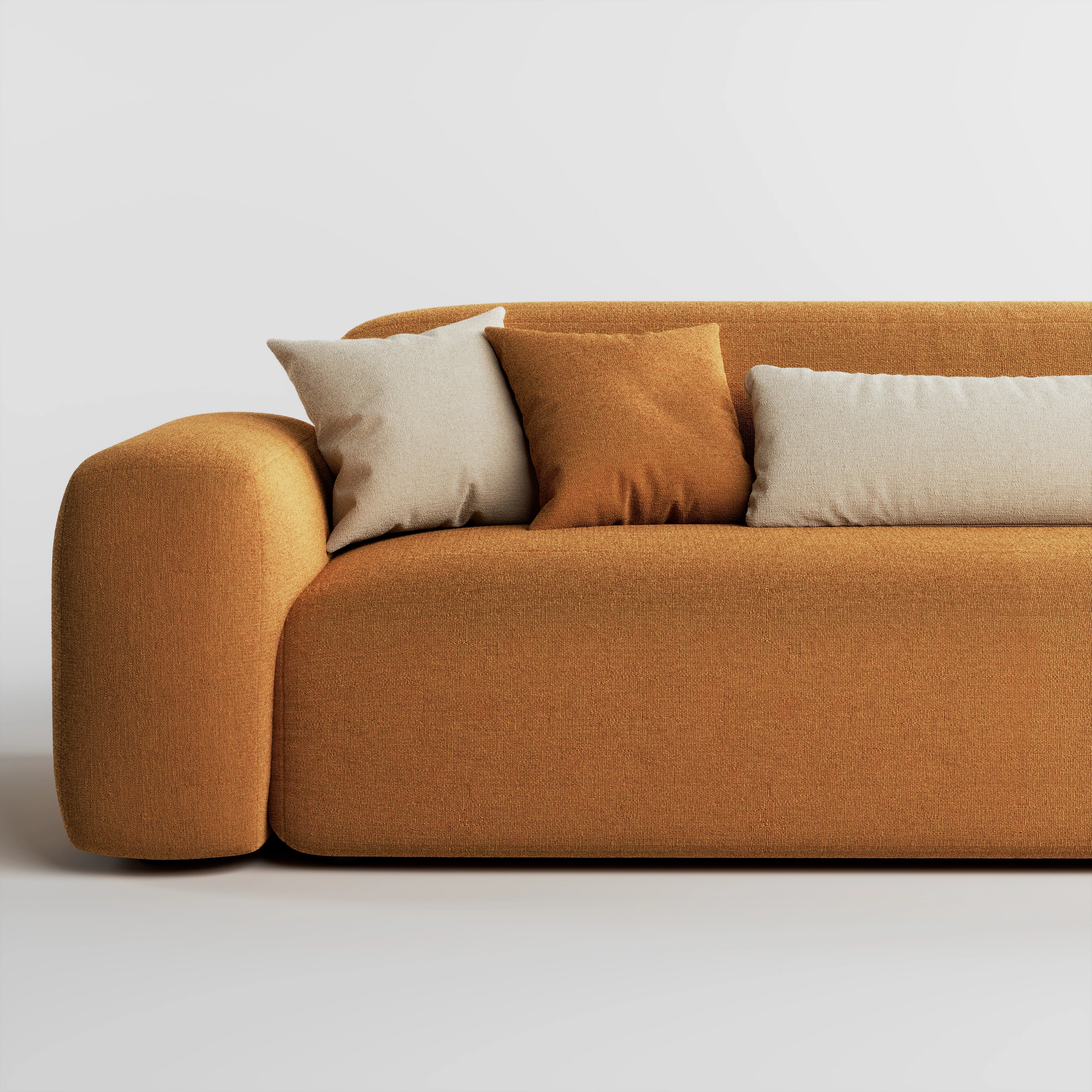 Close up of Cove 3 seater sofa in caramel fabric showing armrest, seat, and cushions